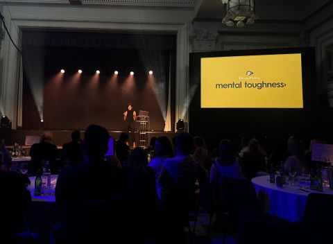Manchester Morson conference stage with Penny Mallory, with audience and dark moody lighting