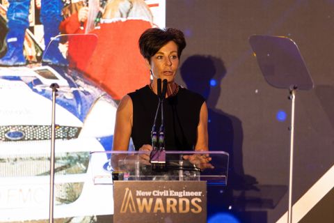 Image of Penny Mallory After dinner Speaker, MC and awards host at the New Civil Engineer Awards in front of a podium.