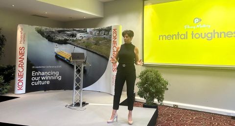 Penny Mallory motivational speaker on stage at KoneCranes conference